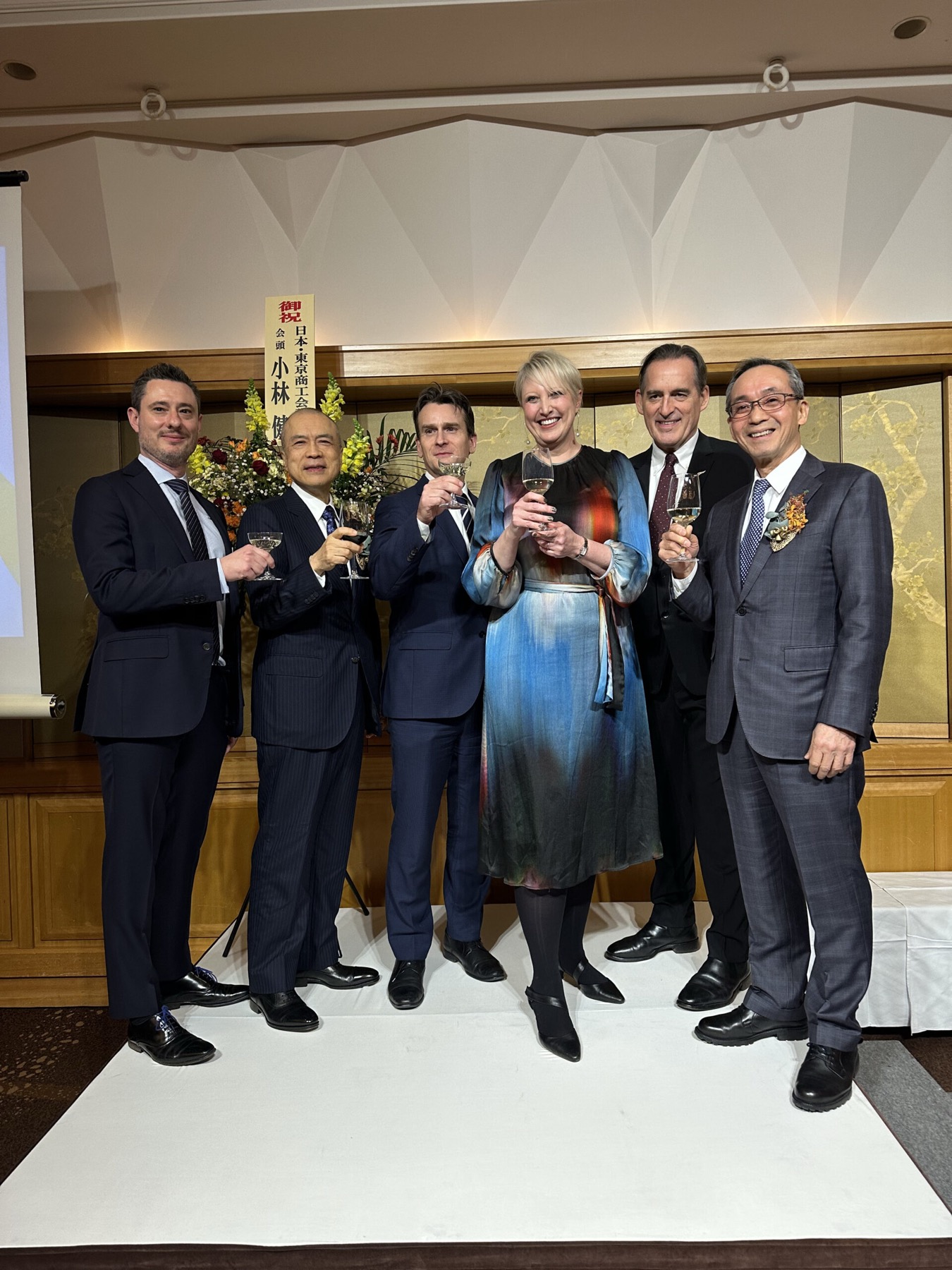Six guests raising glasses at an ANZCCJ function
